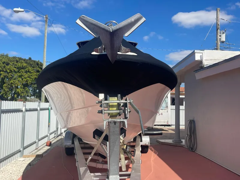 Slide: The Image of 2006 Wellcraft 310 CC boat on trailer in driveway. - 10