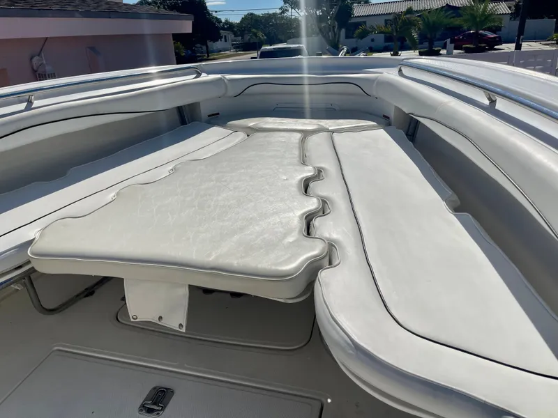 Slide: The Image of 2006 Wellcraft 310 CC boat with white cushioned seating area. - 12