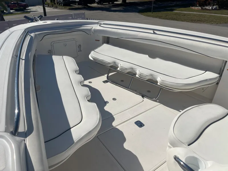 Slide: The Image of 2006 Wellcraft 310 CC boat interior with white cushioned seating. - 13
