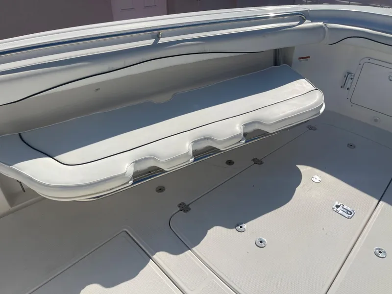 Slide: The Image of 2006 Wellcraft 310 CC boat interior with cushioned seating and storage compartments. - 14
