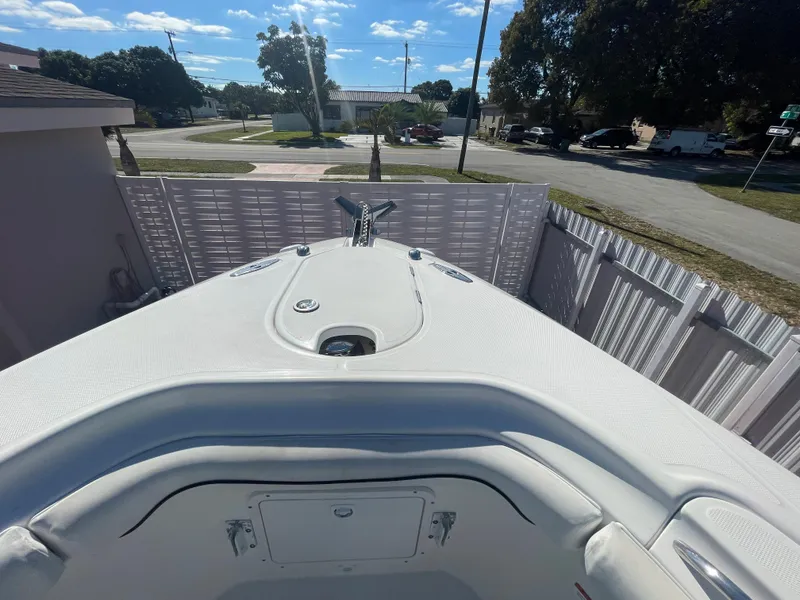 Slide: The Image of 2006 Wellcraft 310 CC boat bow view in a residential area. - 15