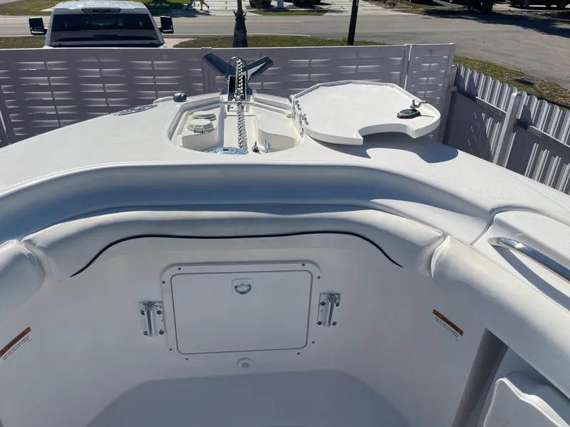 Slide: The Image of 2006 Wellcraft 310 CC boat bow with anchor and storage compartments. - 18