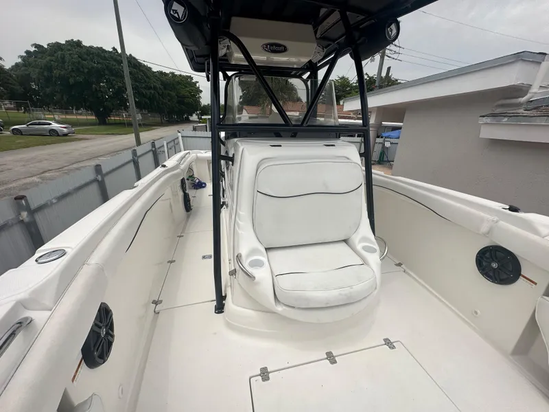 Slide: The Image of 2006 Wellcraft 310 CC boat interior with white seating and black frame. - 23