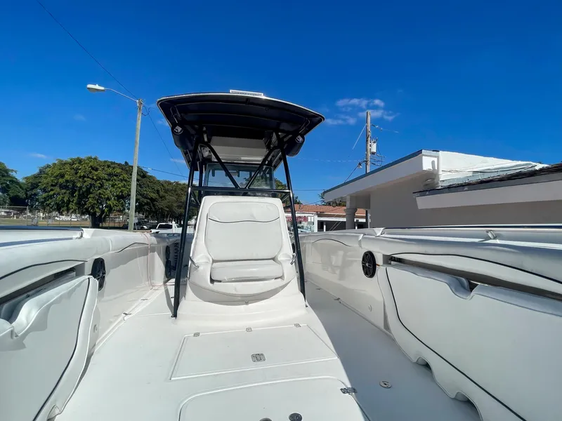 Slide: The Image of 2006 Wellcraft 310 CC boat interior with seating and T-top under clear blue sky. - 25