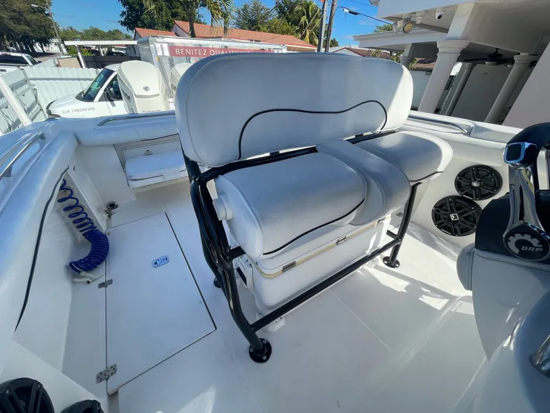 Slide: The Image of 2006 Wellcraft 310 CC boat interior with white seating and black frame. - 27
