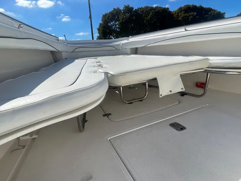 Slide: The Image of 2006 Wellcraft 310 CC boat interior with white cushioned seating. - 31