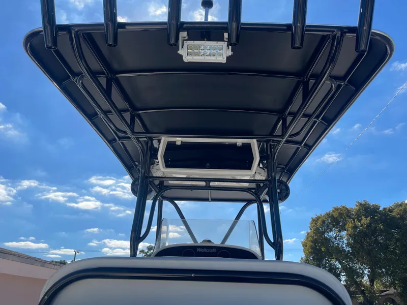 Slide: The Image of 2006 Wellcraft 310 CC boat with T-top against blue sky. - 33