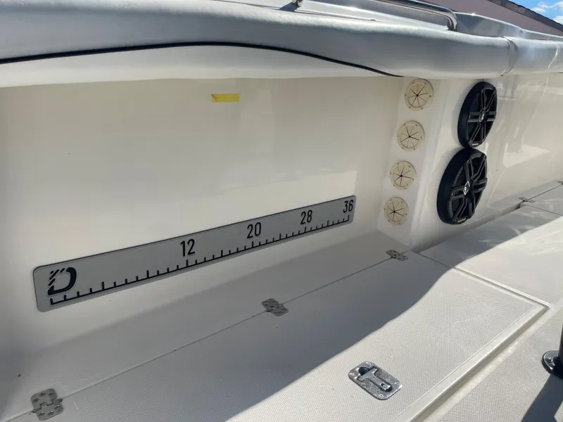 Slide: The Image of 2006 Wellcraft 310 CC boat interior with built-in speakers and measurement scale. - 34