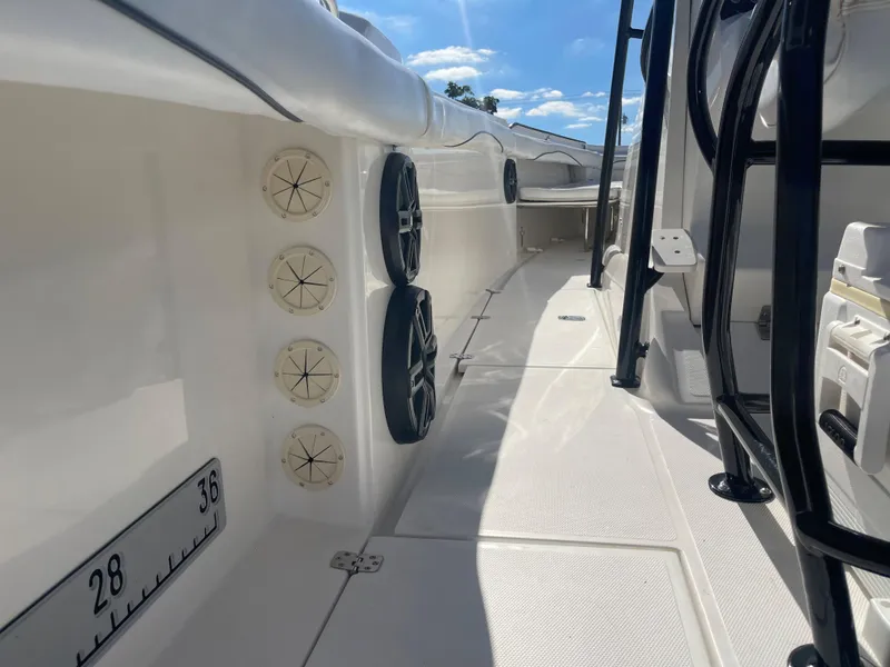 Slide: The Image of 2006 Wellcraft 310 CC boat deck with speakers and rod holders. - 35