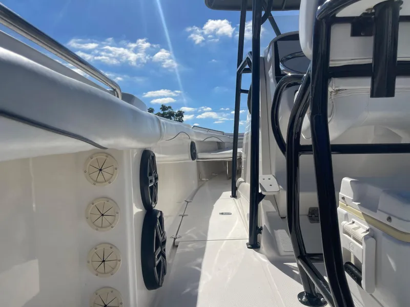 Slide: The Image of 2006 Wellcraft 310 CC boat deck with speakers and seating under a sunny sky. - 36