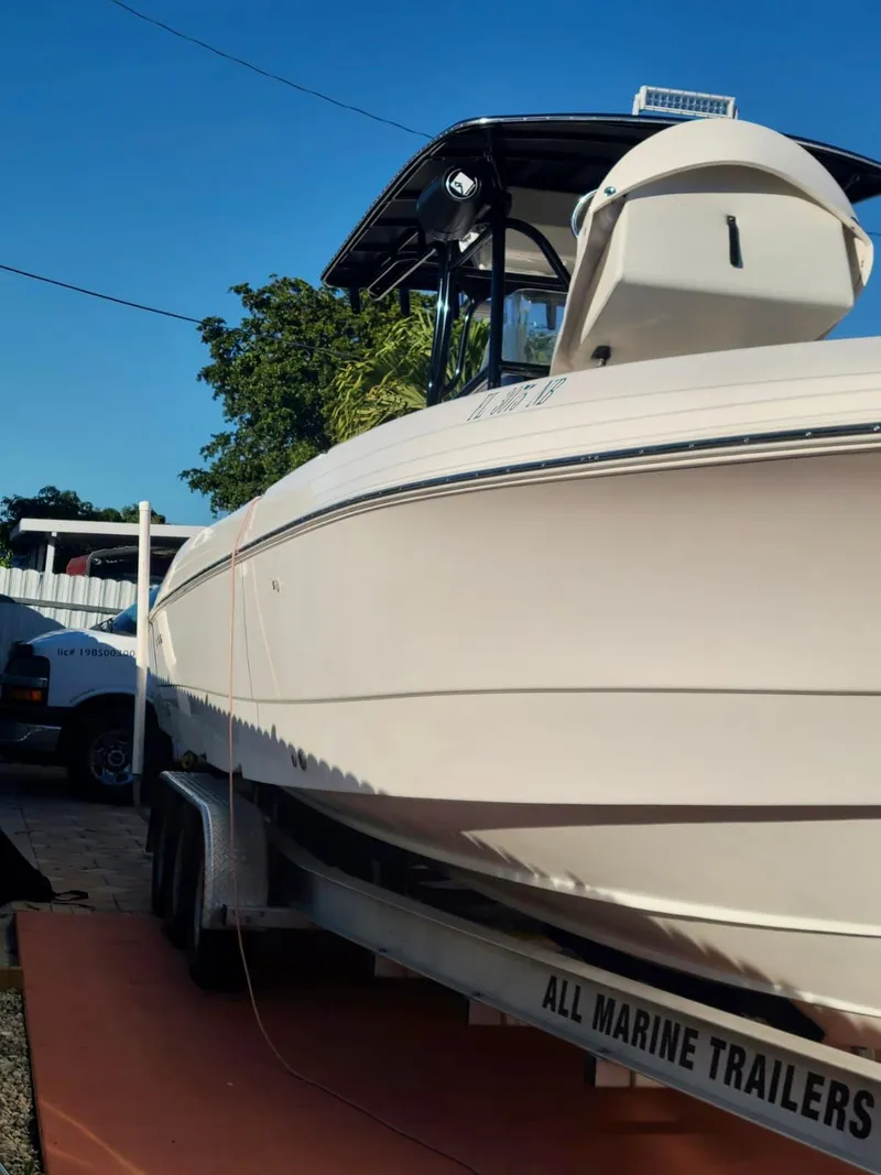 Slide: The Image of 2006 Wellcraft 310 CC boat on trailer in outdoor setting. - 4