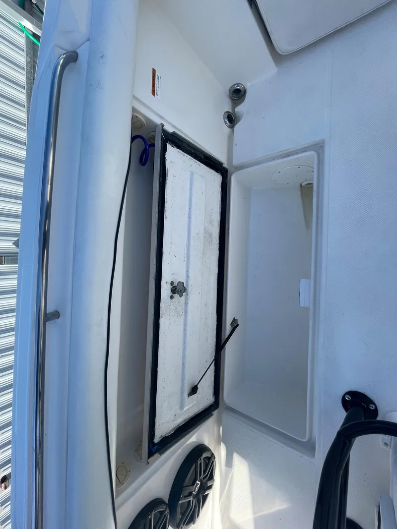 Slide: The Image of 2006 Wellcraft 310 CC boat interior with storage compartments. - 44