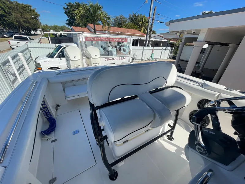 Slide: The Image of 2006 Wellcraft 310 CC boat interior with white seating and steering console. - 45