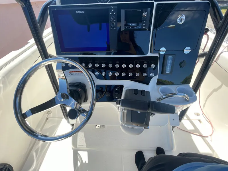 Slide: The Image of 2006 Wellcraft 310 CC boat helm with steering wheel and navigation controls. - 47