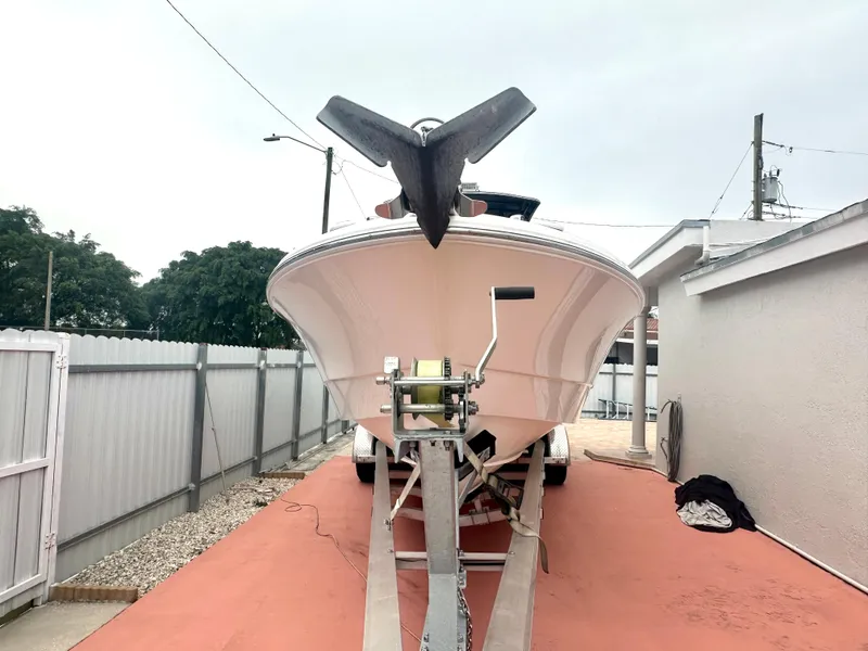 Slide: The Image of 2006 Wellcraft 310 CC boat on a trailer in a driveway. - 5