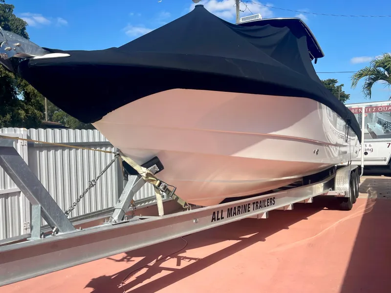 Slide: The Image of 2006 Wellcraft 310 CC boat on trailer with black cover. - 6