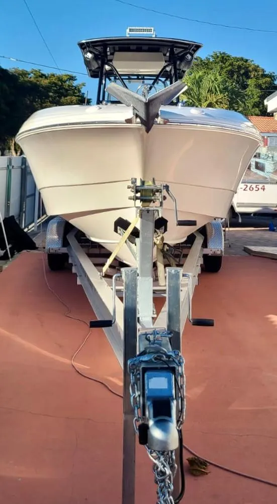 Slide: The Image of 2006 Wellcraft 310 CC boat on a trailer in a driveway. - 8