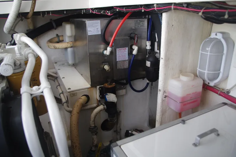 Slide: The Image of Engine compartment of a 2000 Cabo 35 Express boat with various mechanical components. - 21