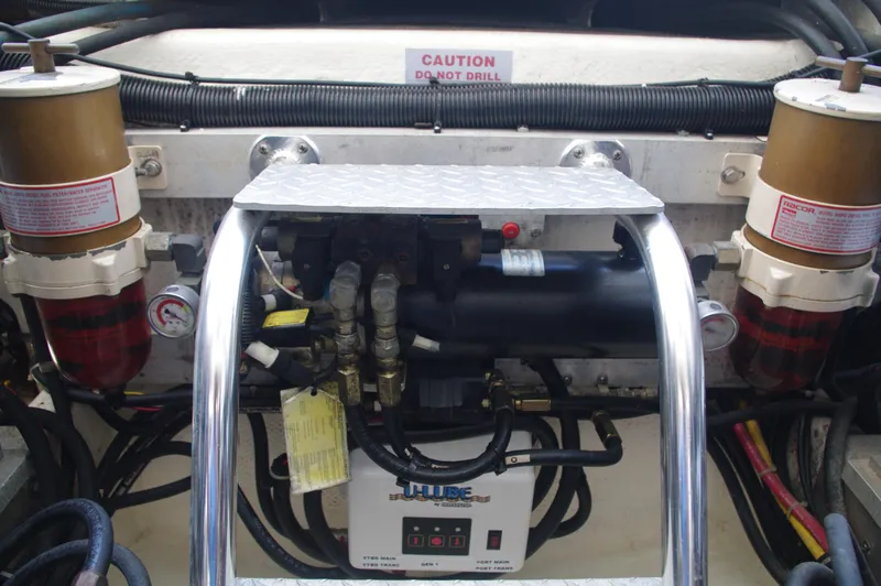 Slide: The Image of Engine compartment of a 2000 Cabo 35 Express boat with fuel filters and hydraulic system. - 25