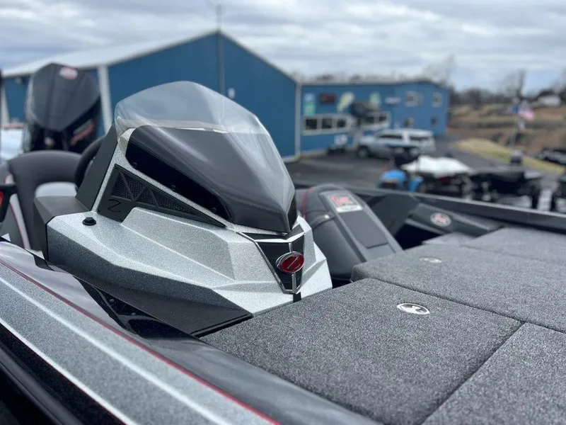 Slide: The Image of 2023 Ranger Z518 boat with sleek design and modern features in a marina. - 6