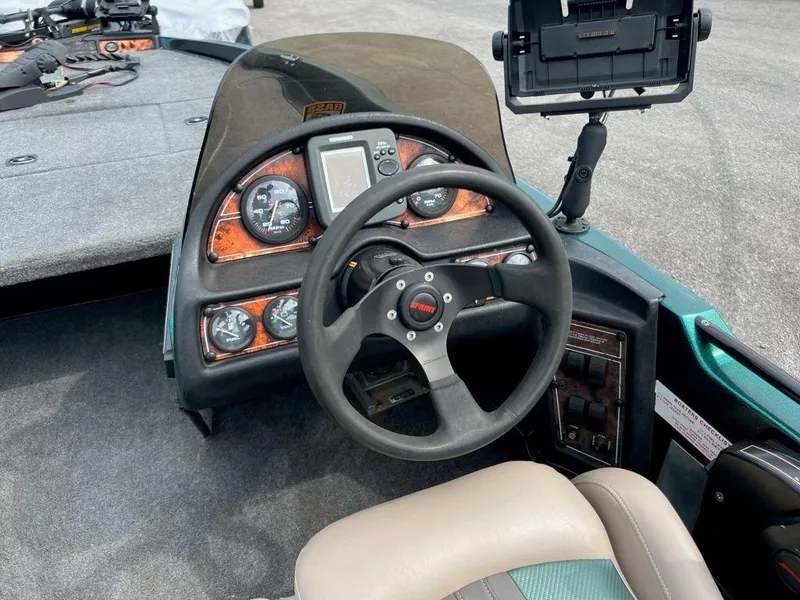 Slide: The Image of 1999 Sprint 286 Pro boat dashboard with steering wheel and instrument panel. - 2