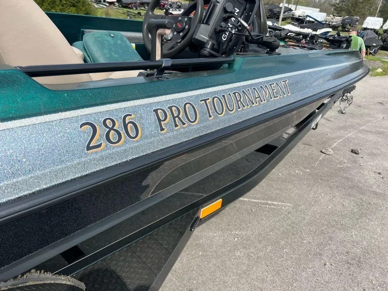 Slide: The Image of 1999 Sprint 286 Pro Tournament fishing boat in a parking lot. - 4
