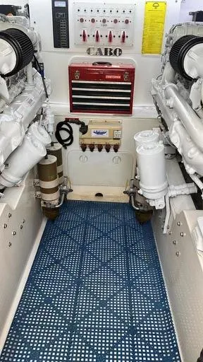 Slide: The Image of Engine room of a 2003 Cabo Express boat, featuring dual engines and control panel. - 8