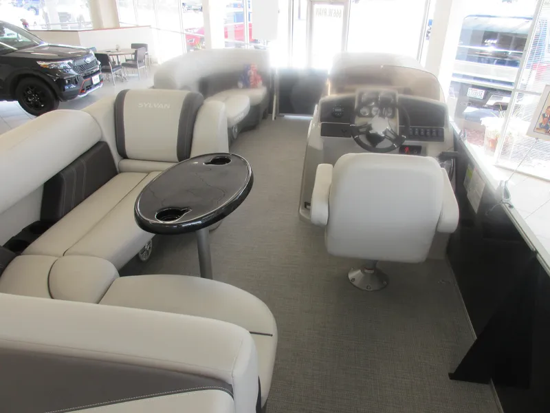 Slide: The Image of 2023 Sylvan 820 Mirage Cruise RE interior with plush seating and modern helm. - 4