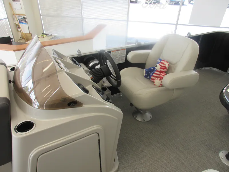 Slide: The Image of Captain's seat of 2023 Sylvan 820 Mirage Cruise RE boat with steering wheel and dashboard. - 6