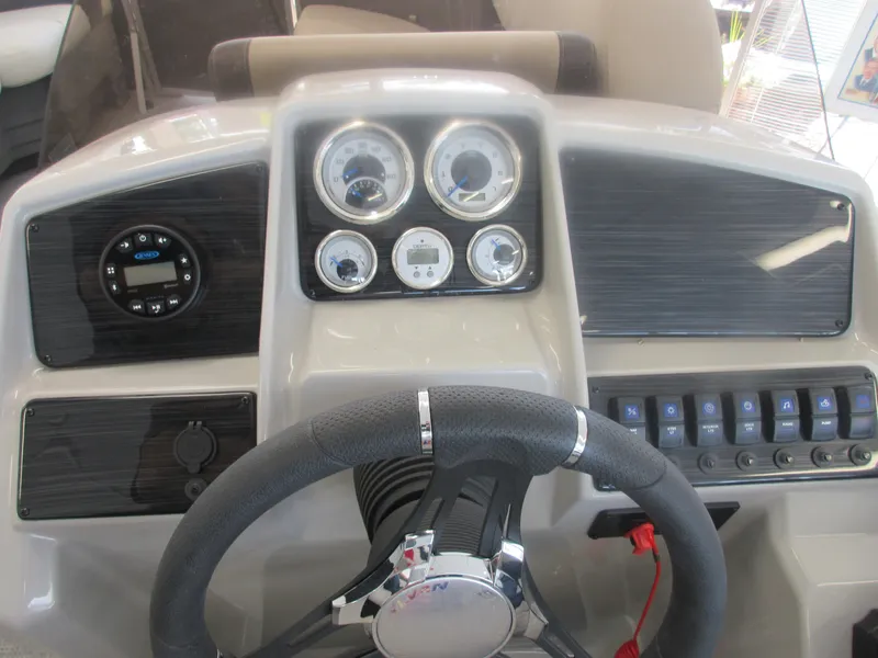 Slide: The Image of 2023 Sylvan 820 Mirage Cruise RE dashboard with steering wheel and control panel. - 7