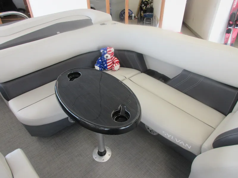 Slide: The Image of 2023 Sylvan 820 Mirage Cruise RE interior with seating and table. - 8