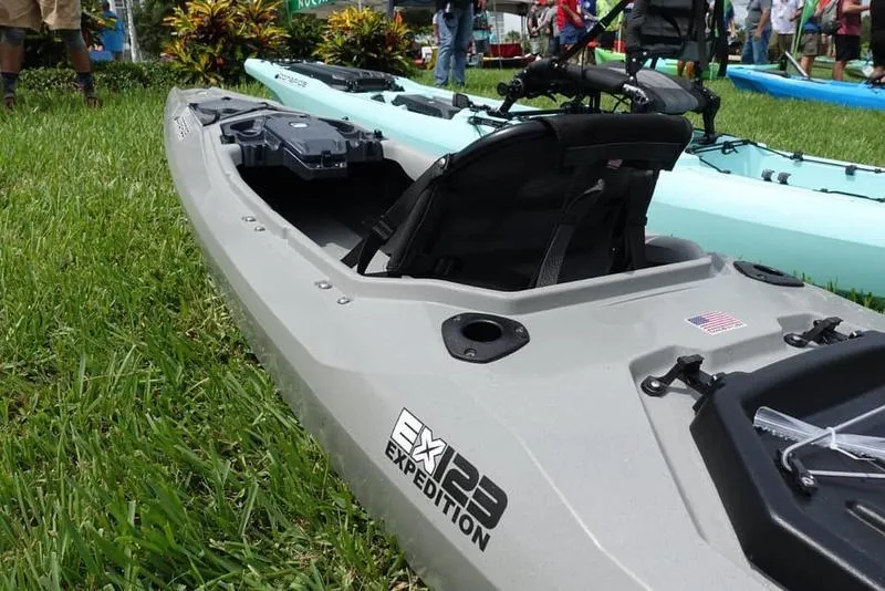 Slide: The Image of Custom EX123 GREY 2022 kayak on grass at outdoor event. - 2
