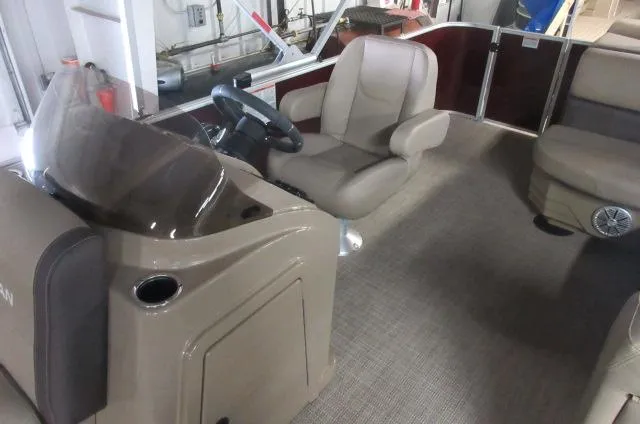 Slide: The Image of 2023 Sylvan 8520 Mirage Cruise boat interior with captain's chair and steering console. - 3