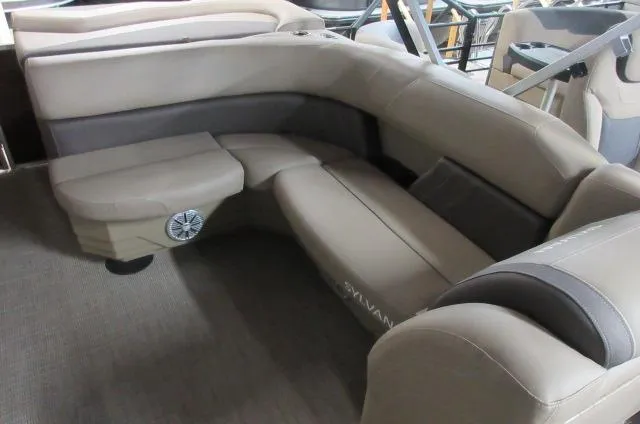 Slide: The Image of 2023 Sylvan 8520 Mirage Cruise boat interior with beige seating. - 5