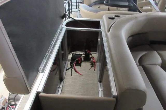 Slide: The Image of 2023 Sylvan 8520 Mirage Cruise boat interior storage compartment with battery and wiring. - 6
