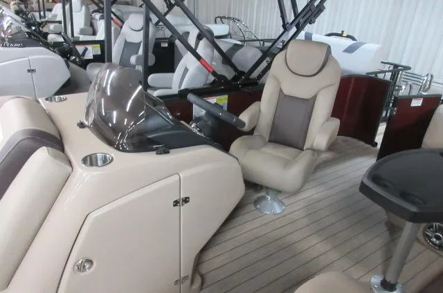 Slide: The Image of 2022 Sylvan L-1 Cruise boat interior with captain's chair and control console. - 2