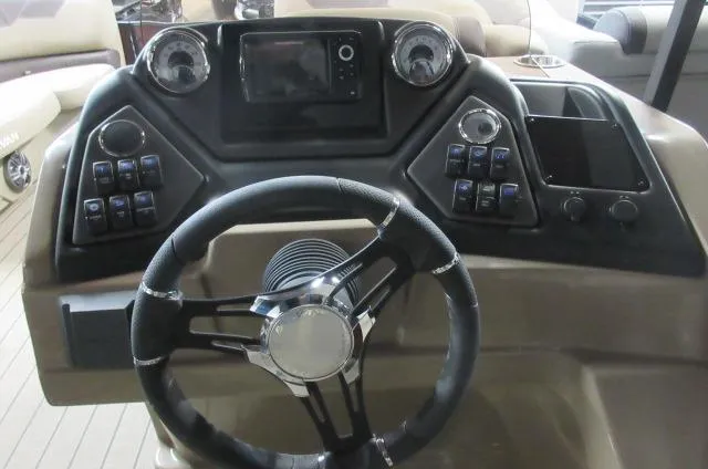 Slide: The Image of 2022 Sylvan L-1 Cruise boat dashboard with steering wheel and control panel. - 5