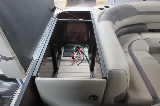 Slide: The Image of 2022 Sylvan L-1 Cruise boat storage compartment with battery and wiring. - 6