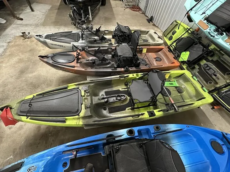 Slide: The Image of 2021 Native Watercraft TITAN PROPEL 12 GRN kayak in a storage area with other kayaks. - 3