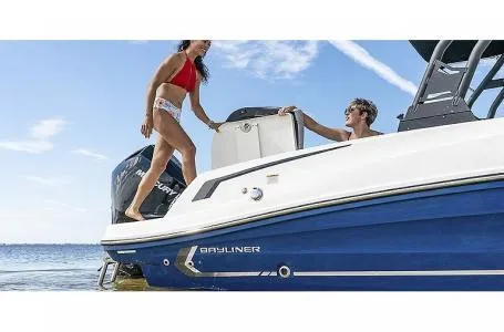 Slide: The Image of 2023 Bayliner VR6 Bowrider Outboard with people enjoying the boat on the water. - 4