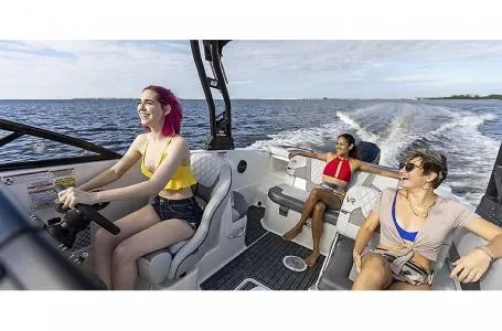 Slide: The Image of 2023 Bayliner VR6 Bowrider Outboard with passengers enjoying a ride on the water. - 7