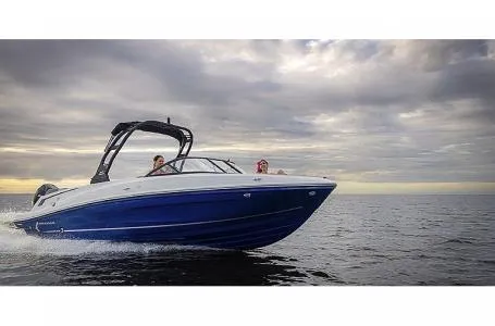 Slide: The Image of 2023 Bayliner VR6 Bowrider Outboard cruising on open water under cloudy sky. - 8