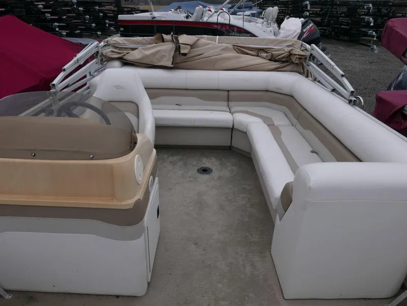 Slide: The Image of 2003 Sylvan 822 Mirage Cruise pontoon boat with beige and white seating. - 5