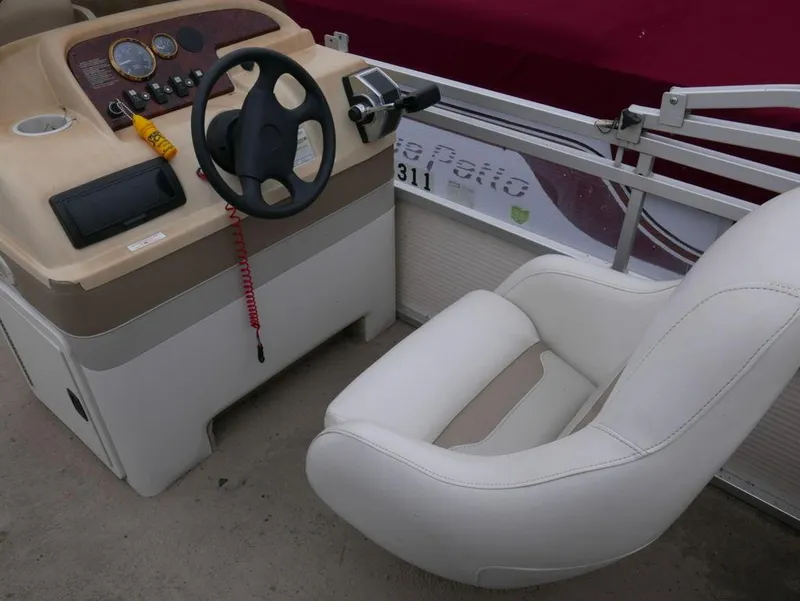 Slide: The Image of 2003 Sylvan 822 Mirage Cruise boat helm with steering wheel and captain's chair. - 7