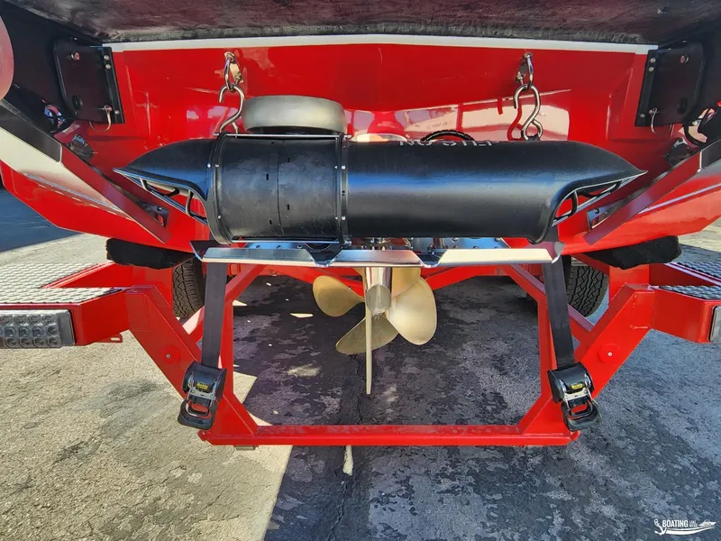 Slide: The Image of 2023 MasterCraft X26 boat underside showing propeller and red hull details. - 11