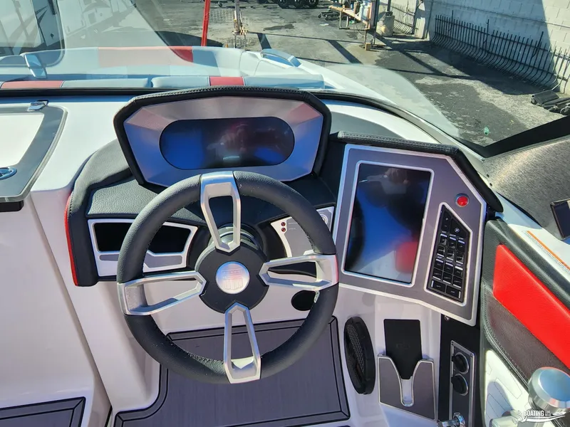 Slide: The Image of 2023 MasterCraft X26 boat dashboard with modern steering and touchscreen controls. - 13