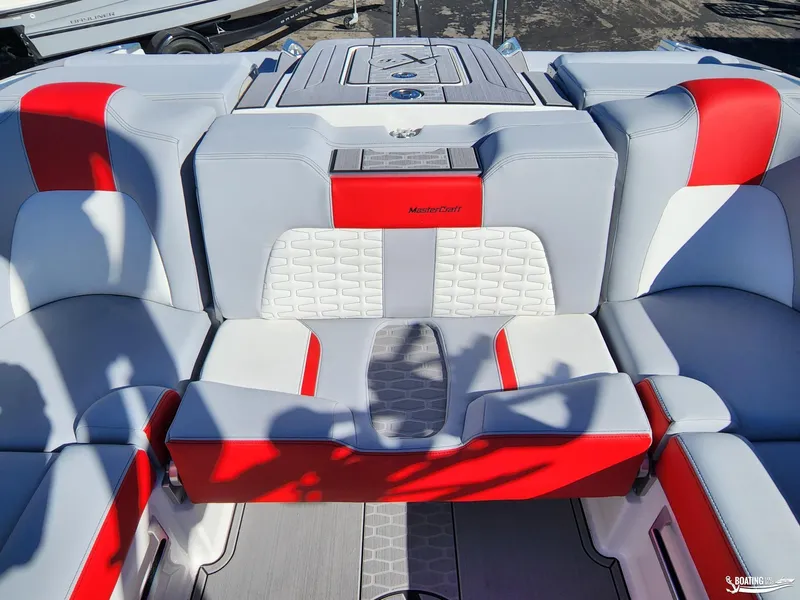 Slide: The Image of 2023 MasterCraft X26 boat interior with red and gray seating. - 17