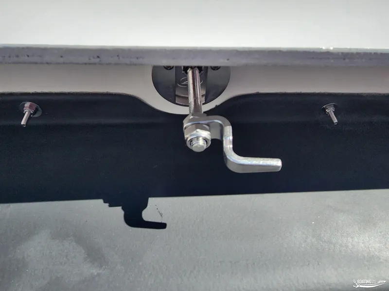 Slide: The Image of Close-up of a 2023 MasterCraft X26 boat component with metal latch and screws. - 19