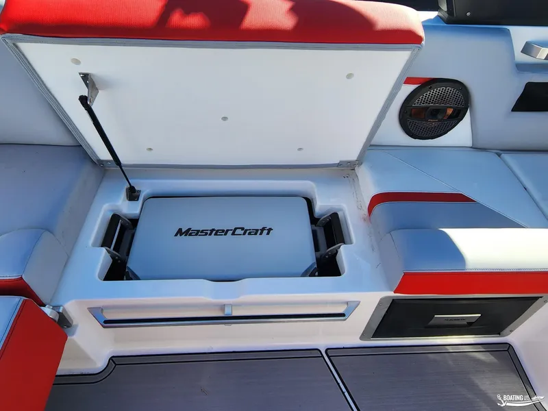 Slide: The Image of 2023 MasterCraft X26 boat interior with open storage compartment and red accents. - 22