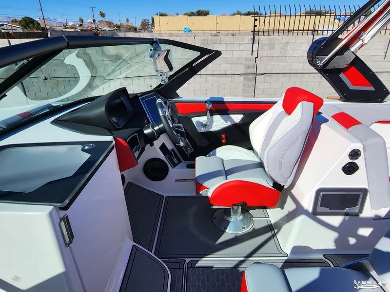 Slide: The Image of 2023 MasterCraft X26 boat interior with modern dashboard and red-accented seating. - 8
